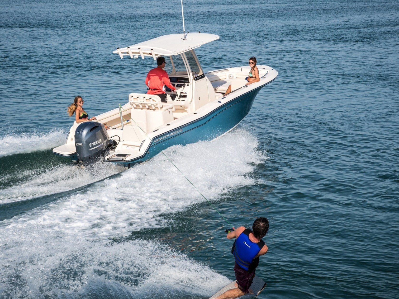 a man riding on the back of a boat in a body of water