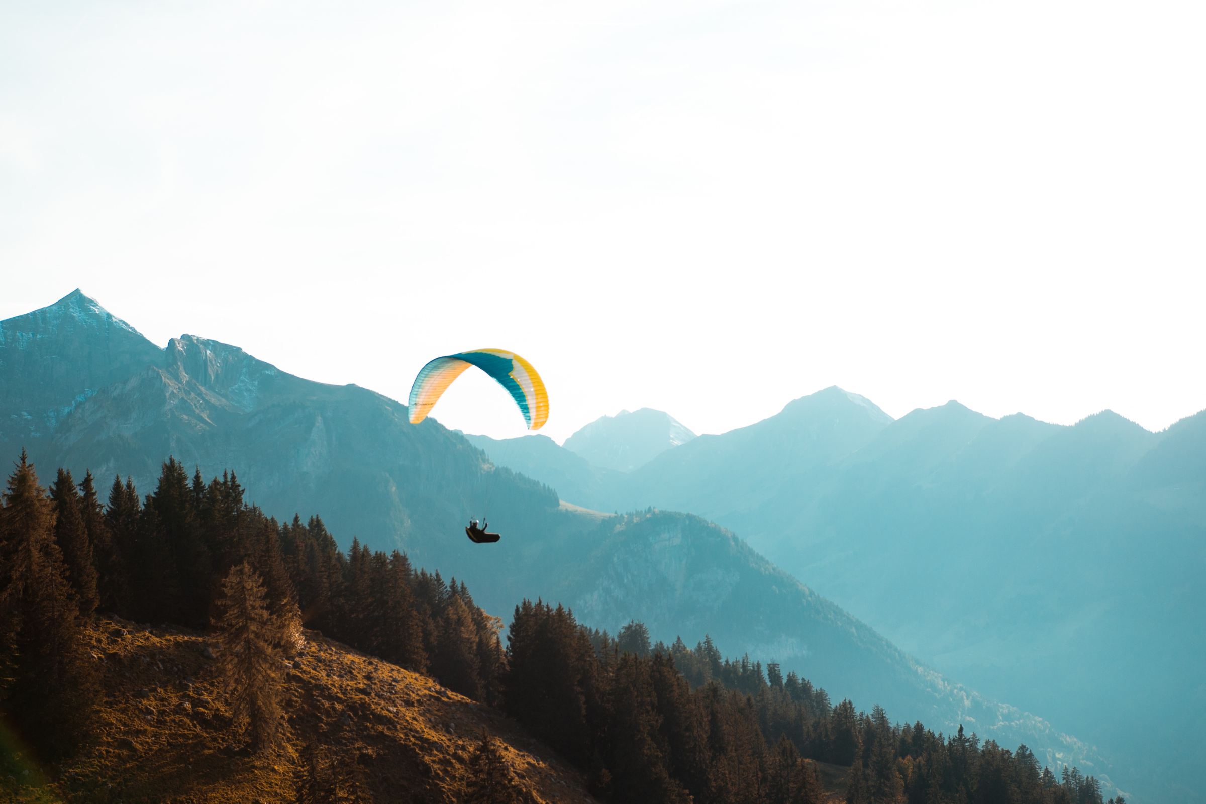 a man flying through the air on top of a mountain